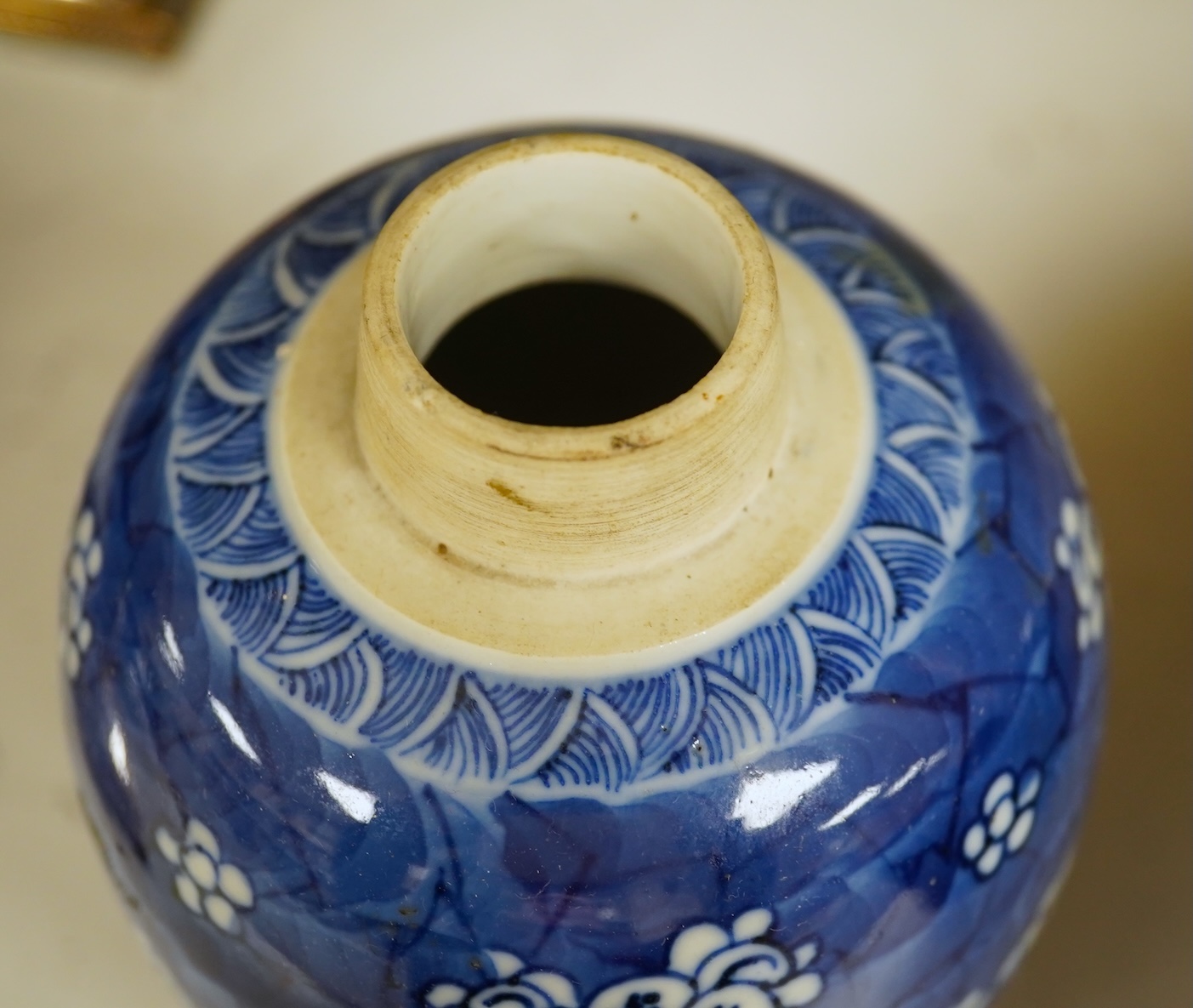 A Chinese powder blue bowl, early 18th century and a Chinese blue and white prunus jar - tallest 13cm. Condition - fair